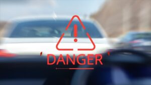 Warning sign with the word "Danger" and a car tailgating closely behind another.