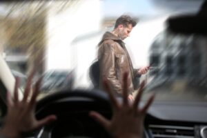 A young man distracted by his phone crosses the street and becomes involved in an accident. Illustrates the dangers of distracted walking in Austin Texas.