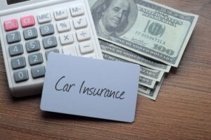 Car Insurance words written on label with calculator