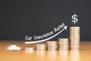 Stacked us quarter coins on wooden table with white illustration shows increasing in car insurance premium rates