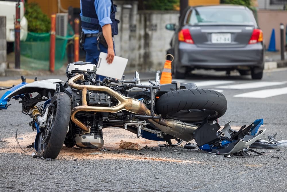 A motorcycle collided with a passenger car at an intersection