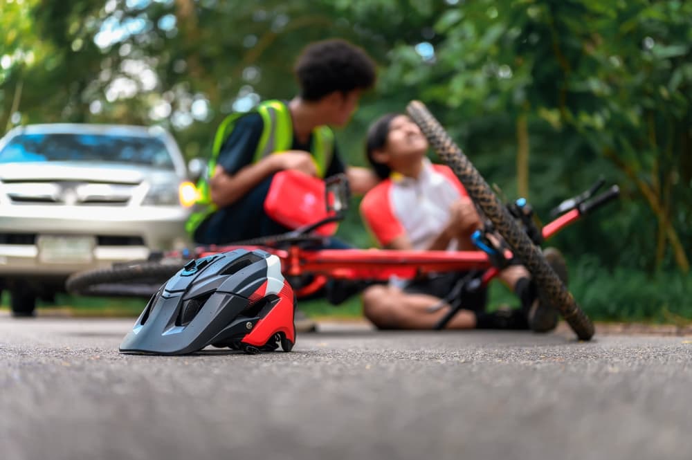 Bicycle Helmet on Street After Mountain Bike Accident Cyclist Falls, Waiting Care from First Aid Staff Assistant urgently