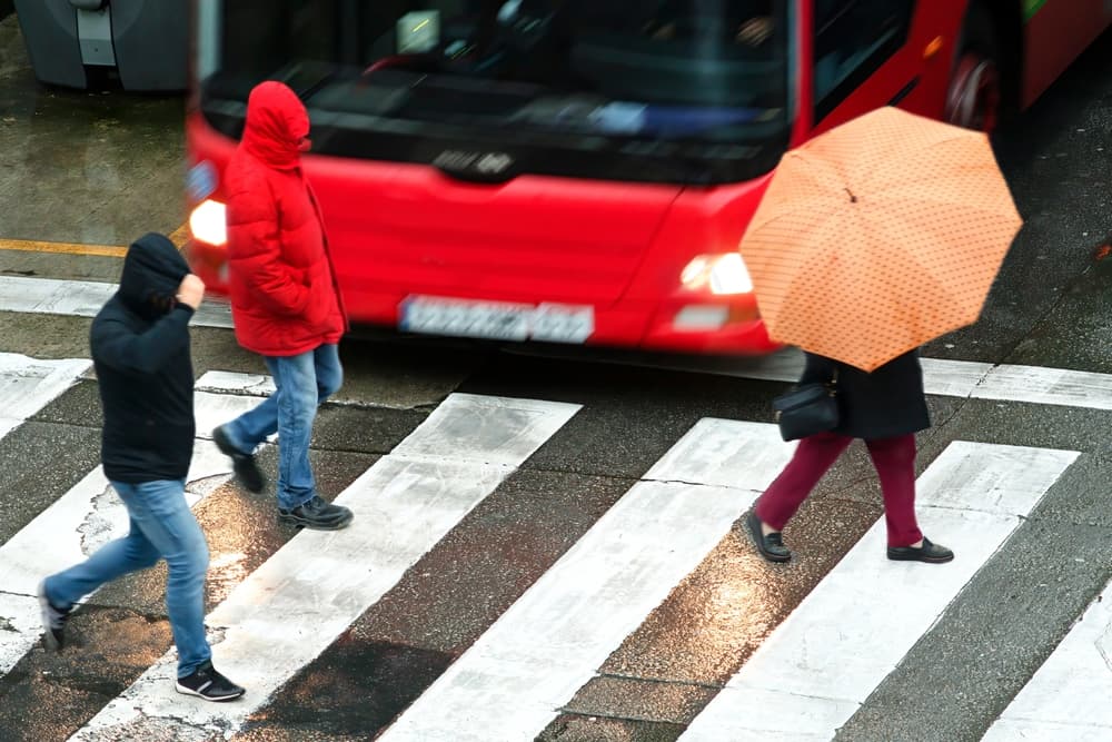 People pedestrian in dangerous situation in crosswalk in city street by vehicles at high speed